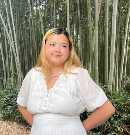 woman in white with bamboo background